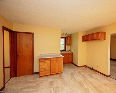 Kitchen with light carpet, brown cabinets, light c