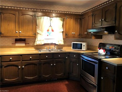 Lots of cabinet space, Stove and Refrigerator stay, gorgeous view of the front yard from the window.