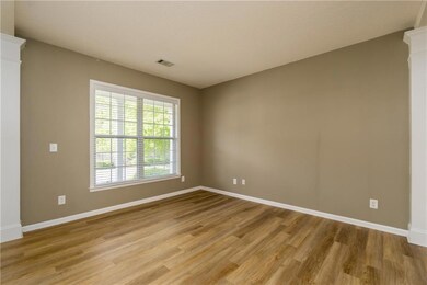 Unfurnished room featuring baseboards, light wood 