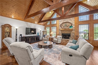 Living area with wood ceiling, hardwood / wood-sty