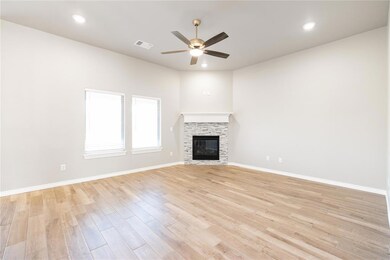 Unfurnished living room with recessed lighting, light wood-style floors, a fireplace, and a ceiling fan