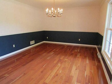 Dining Room. Cherry hardwood, chair rail and large