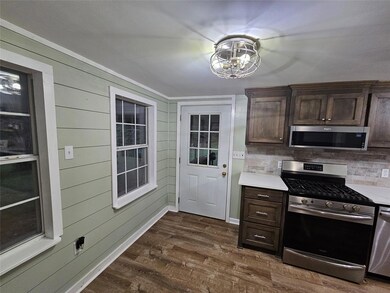 Kitchen with wood walls, stainless steel appliance