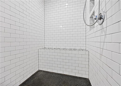 Bathroom featuring a tile shower