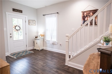 Bright Foyer featuring beautiful floors and stairway