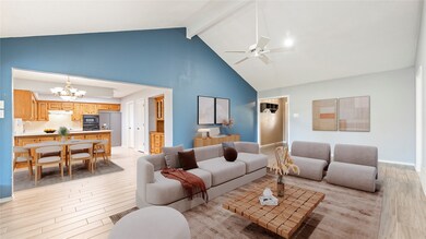 Living area with light wood-style flooring, high vaulted ceiling, beamed ceiling, a ceiling fan, and a chandelier