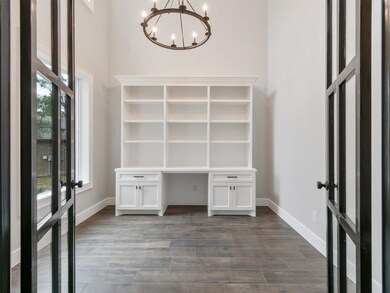 CUSTOM METAL FRENCH DOORS OPEN TO STUDY'S HANDCRAFTED BUILT-INS.