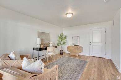 Living area with wood finished floors and baseboards