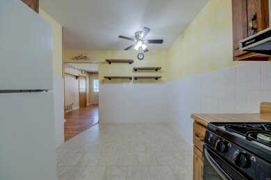Galley kitchen with  gas stove and dishwasher with