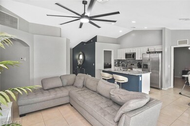 Living area featuring ceiling fan, light tile patt