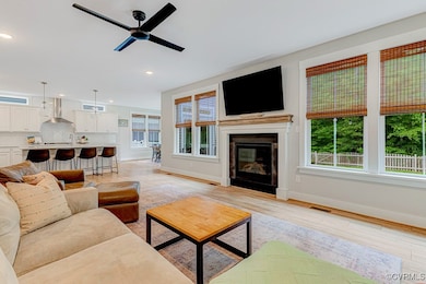 Living room featuring baseboards, a ceiling fan, r