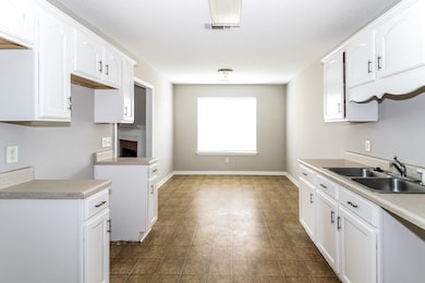 Kitchen with white cabinets and light countertops