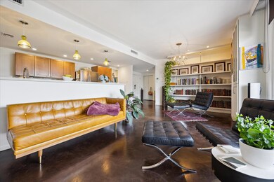 Living room with concrete flooring, a chandelier,