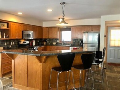 The spacious and updated kitchen has a two tiered 