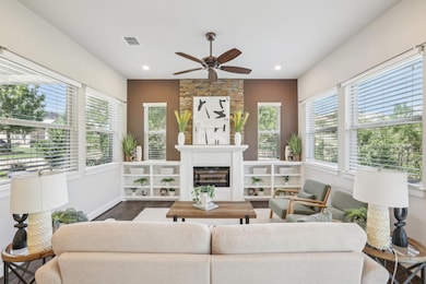 Living area with dark wood-style floors, a glass 