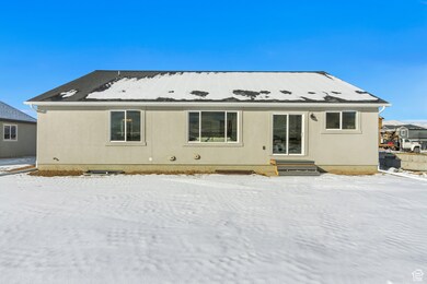View of snow covered back of property