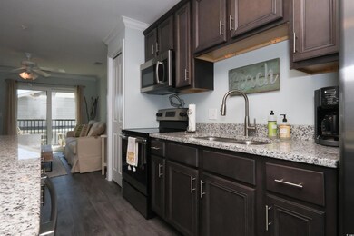 Kitchen featuring stainless steel microwave, ornam