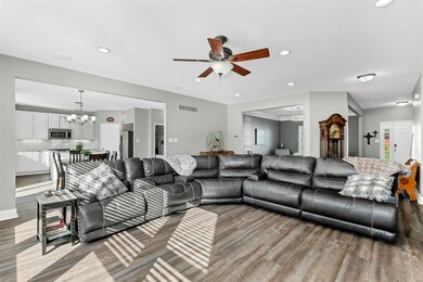 Another view of the living room with ceiling fan a