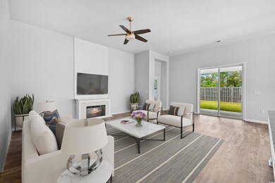 Living room featuring ceiling fan and hardwood / w