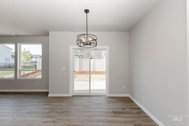 Unfurnished dining area featuring a chandelier and light wood-style floors