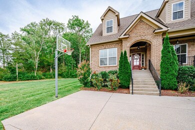 Front of home with basketball hoop.