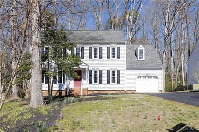 Colonial-style house featuring a garage and a fron