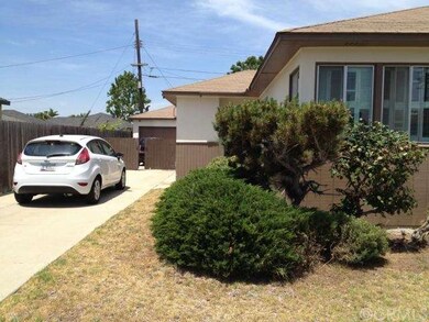 Front of house showing long driveway with the gara