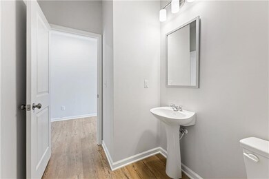 Bathroom with wood-type flooring, toilet, and sink
