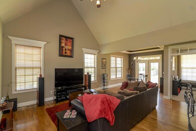 The family room is open to the dining and kitchen and boasts soaring ceilings, designer paint colors and is flooded with natural light.