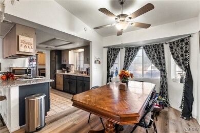 Dining room featuring ceiling fan, vaulted ceiling