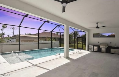Swimming pool featuring ceiling fan, a lanai, a sunroom, a patio area, and area for grilling