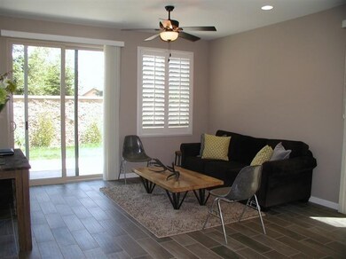 Living room with dimmers in ceiling and slider to 