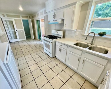 Kitchen featuring white gas range, tasteful backsp