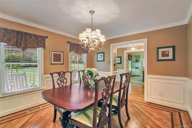 Formal dining room features oak floors with custom