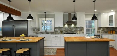 Remodeled kitchen with leathered marble counters, two ovens, two islands, pot filler and tons of storage!!