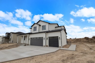View of front of house with a garage, driveway, and covered porch