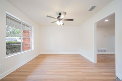 Spare room with a ceiling fan and light wood-style flooring