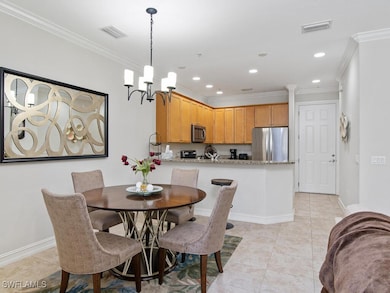 Dining room with ornamental molding, light tile pa