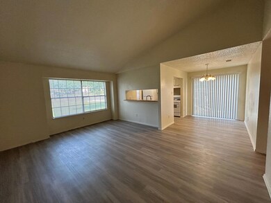 Unfurnished living room with a chandelier, dark w
