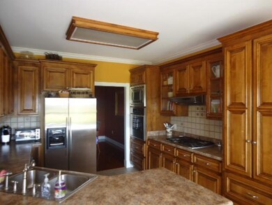Kitchen - Bar area, tile backsplash, SS kitchen appliances to remain, tile floors