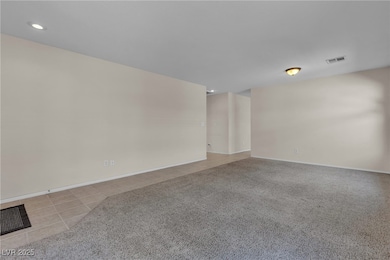 Empty room featuring recessed lighting, light tile