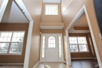 Two story vaulted foyer with the den and dining ro
