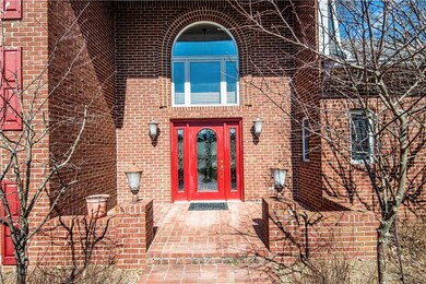 Front porch has space for outdoor furniture and a variety of plant buckets and boxes.