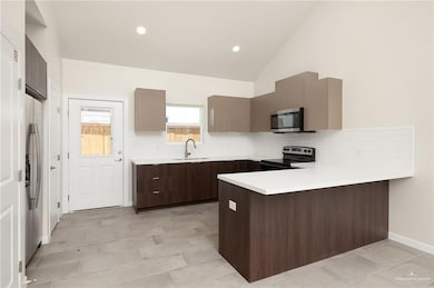 Kitchen featuring a peninsula, light countertops, appliances with stainless steel finishes, backsplash, and recessed lighting