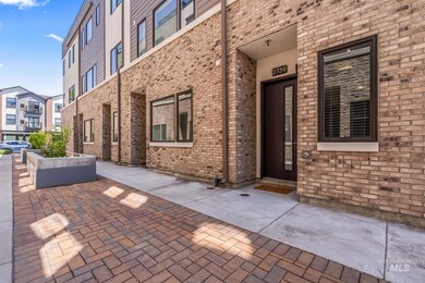 View of exterior entry featuring brick siding