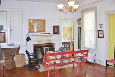 Living room with woodburning fplc and original wal