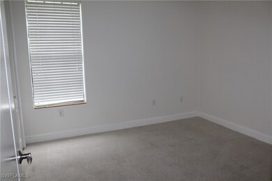 Carpeted empty room with baseboards