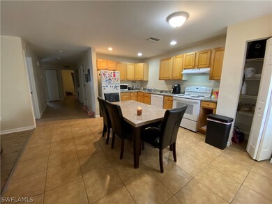 Kitchen dining area. Tiled floor and pantry.