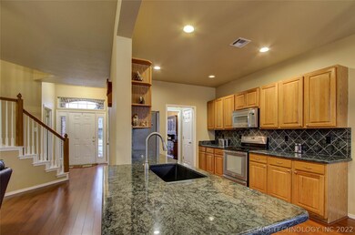 Kitchen overlooks family room so you can watch TV