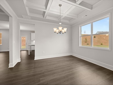 Westerly open dining room with a chandelier and coffered ceilings